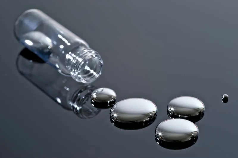 What are the Dangers of Mercury Contamination in Drinking Water, mercury liquid spilling from a glass vial onto a table top