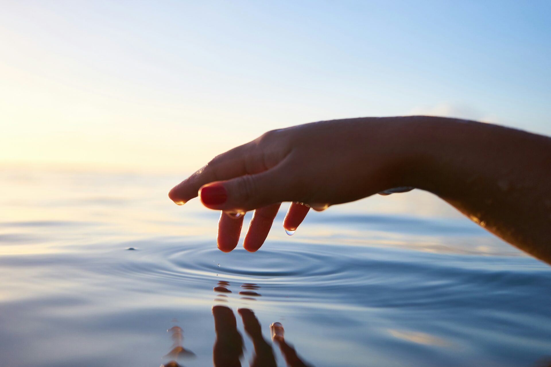 How to save water, hand grazing the surface of a lake